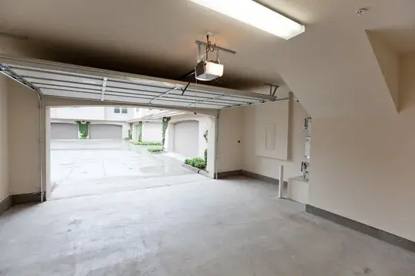 Open sectional garage door with a ceiling-mounted opener